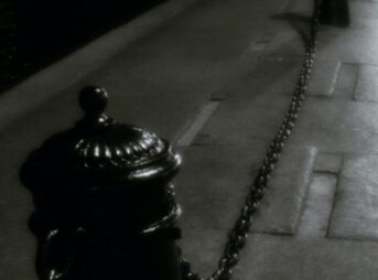 black steel bollards on sidewalk during nighttime