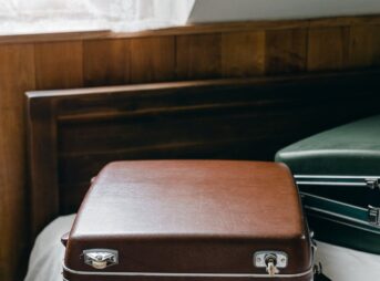 suitcases placed on edge of bed