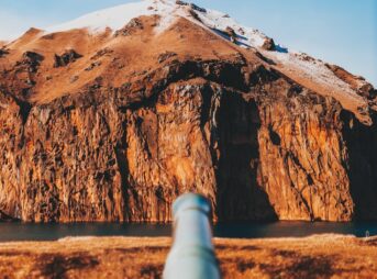 steel pipe against rocky mountain