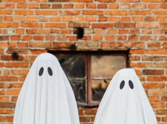 ghosts in front of a brick wall